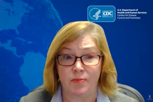 Nicole Fehrenbach faces the camera and speaks on a video call. The background features a CDC logo and a stylized map. 