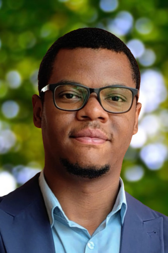 Valentin Disashi stands for photo outside under trees