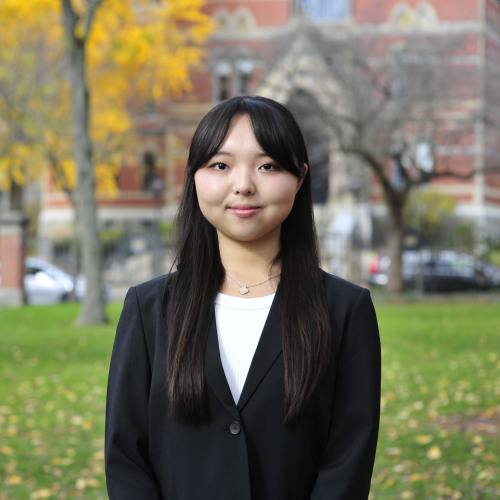 Reia Lee stands outside while facing a cmaera for a picture